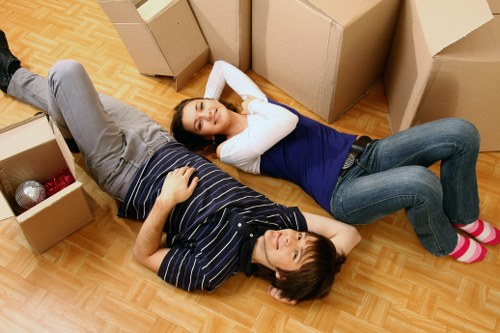 Movers handling items at a Victorian terrace with narrow access in Balham